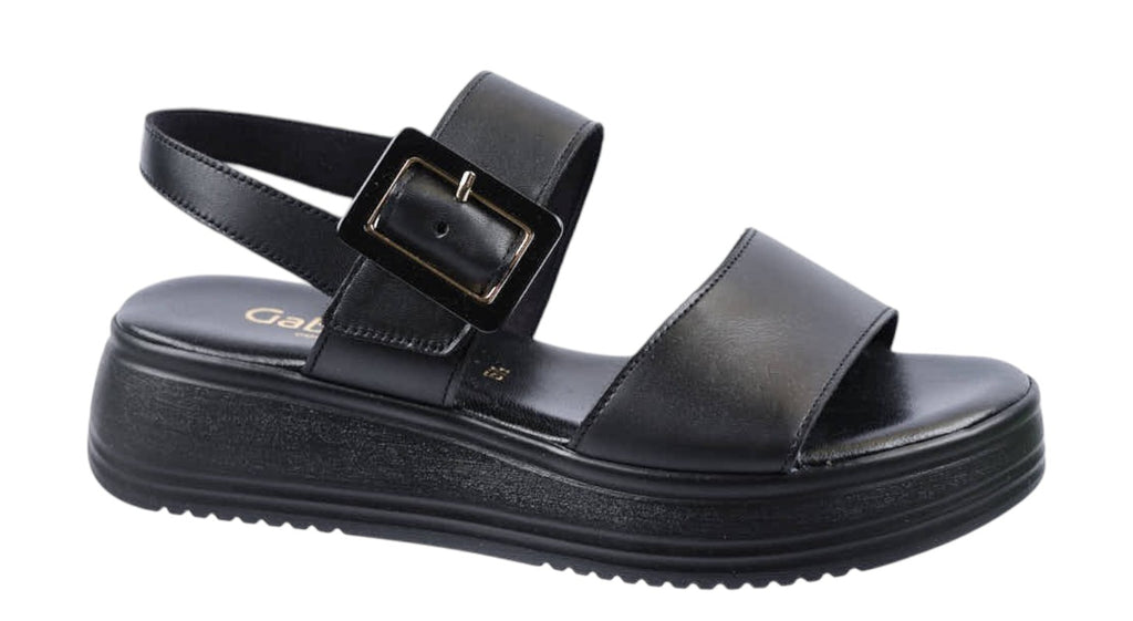 flat sandals in black leather with buckle side strap and ankle strap
